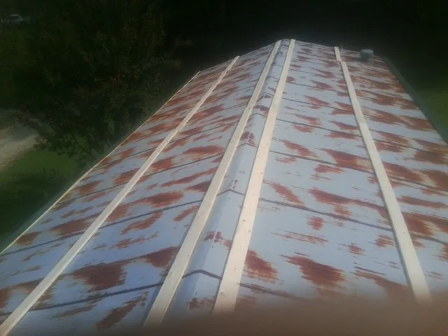 Rusted metal roof panels with new wood purlins before replacement — Storm Damage Roof Repair in Newman by Roofing Brothers
