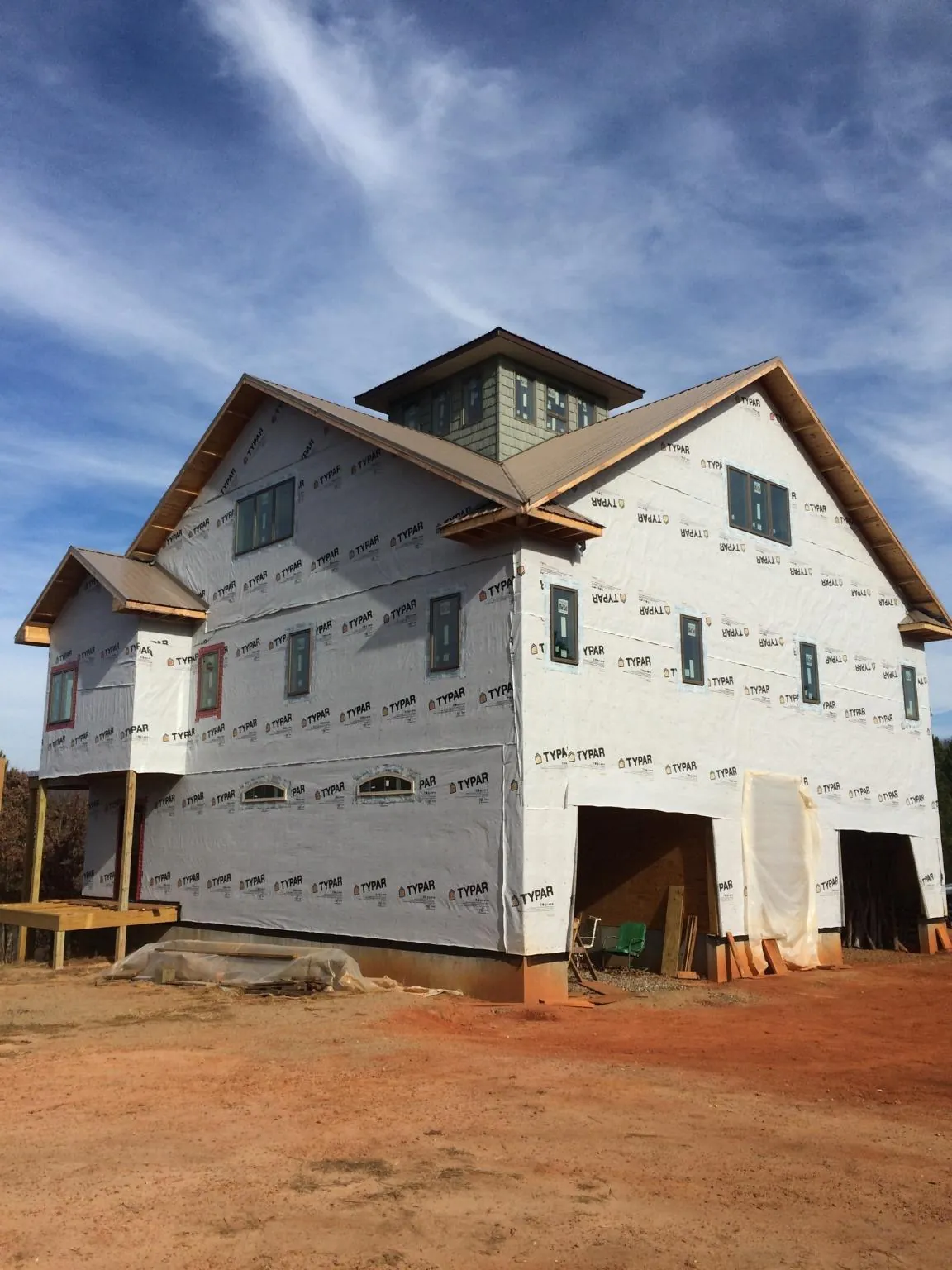 New two story house under construction with a cupola and gabled roofs in Newman